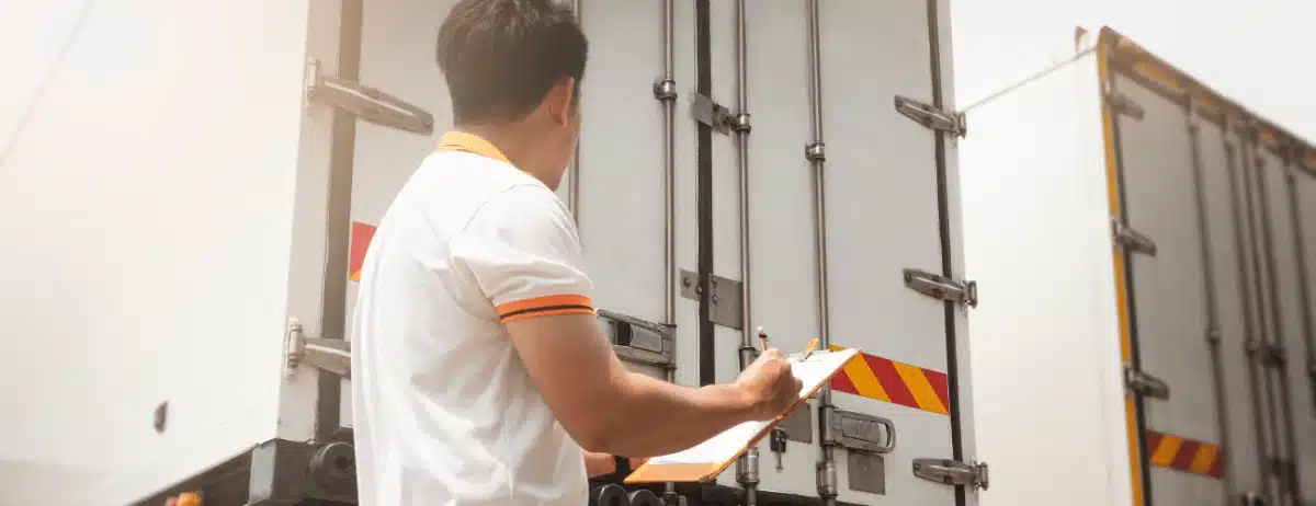 DOT Inspection Level 6: Inspector reviewing multiple trucks