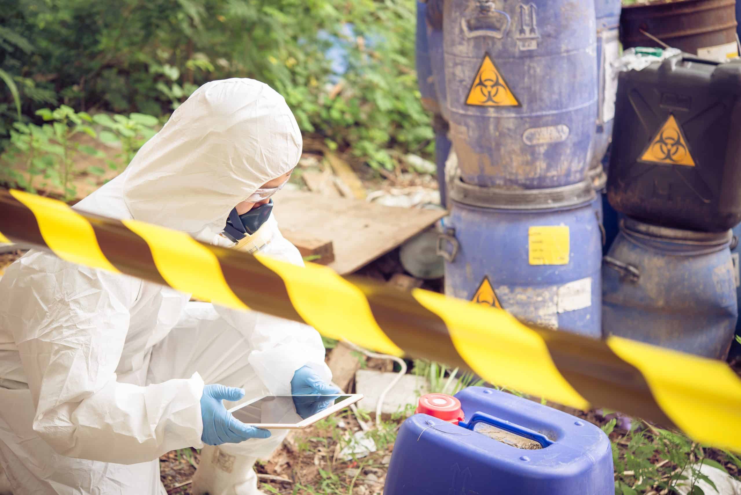 worker in biohazard_hazmat suit with chemicals