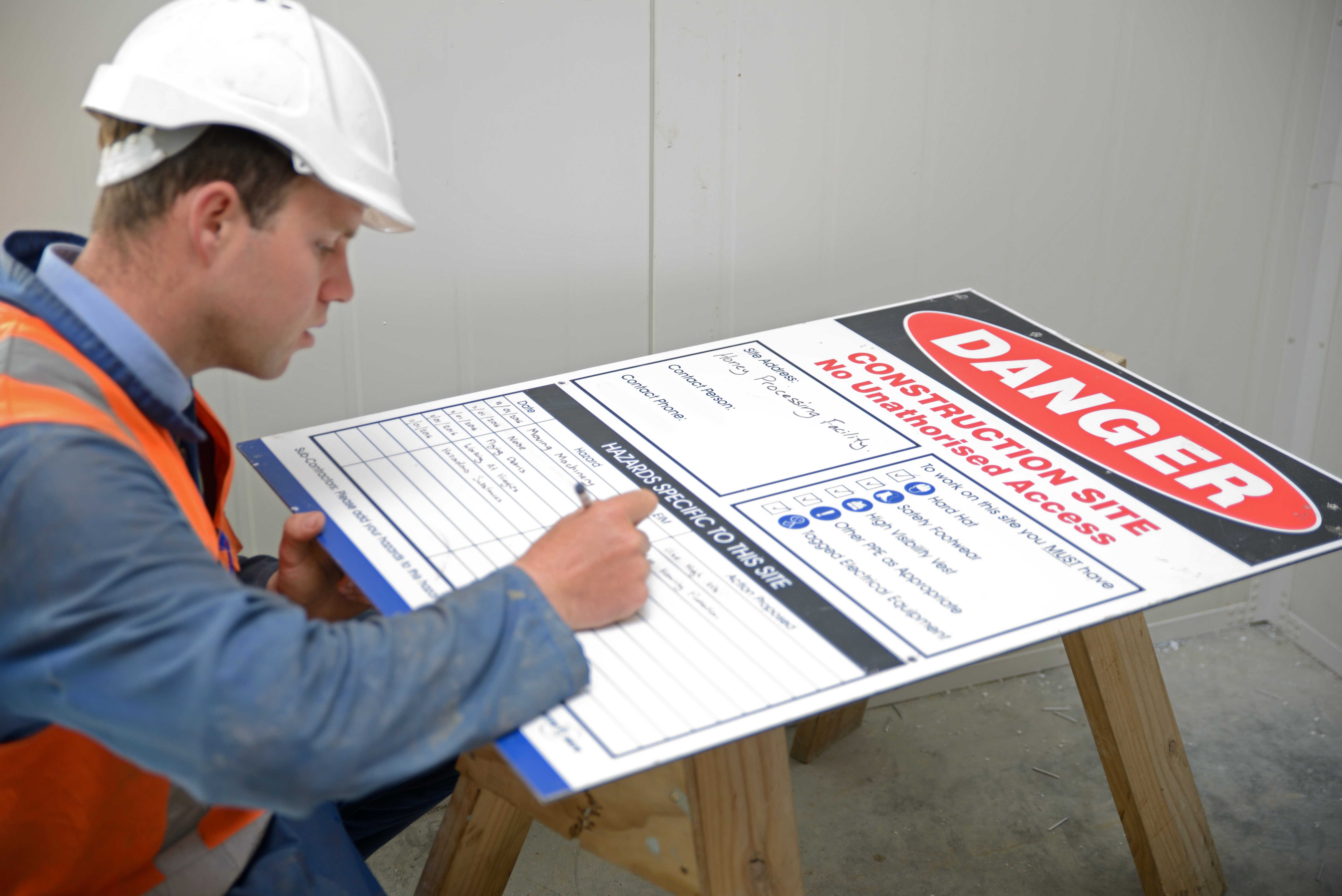 An OSHA inspector checks the hazards board at a construction site