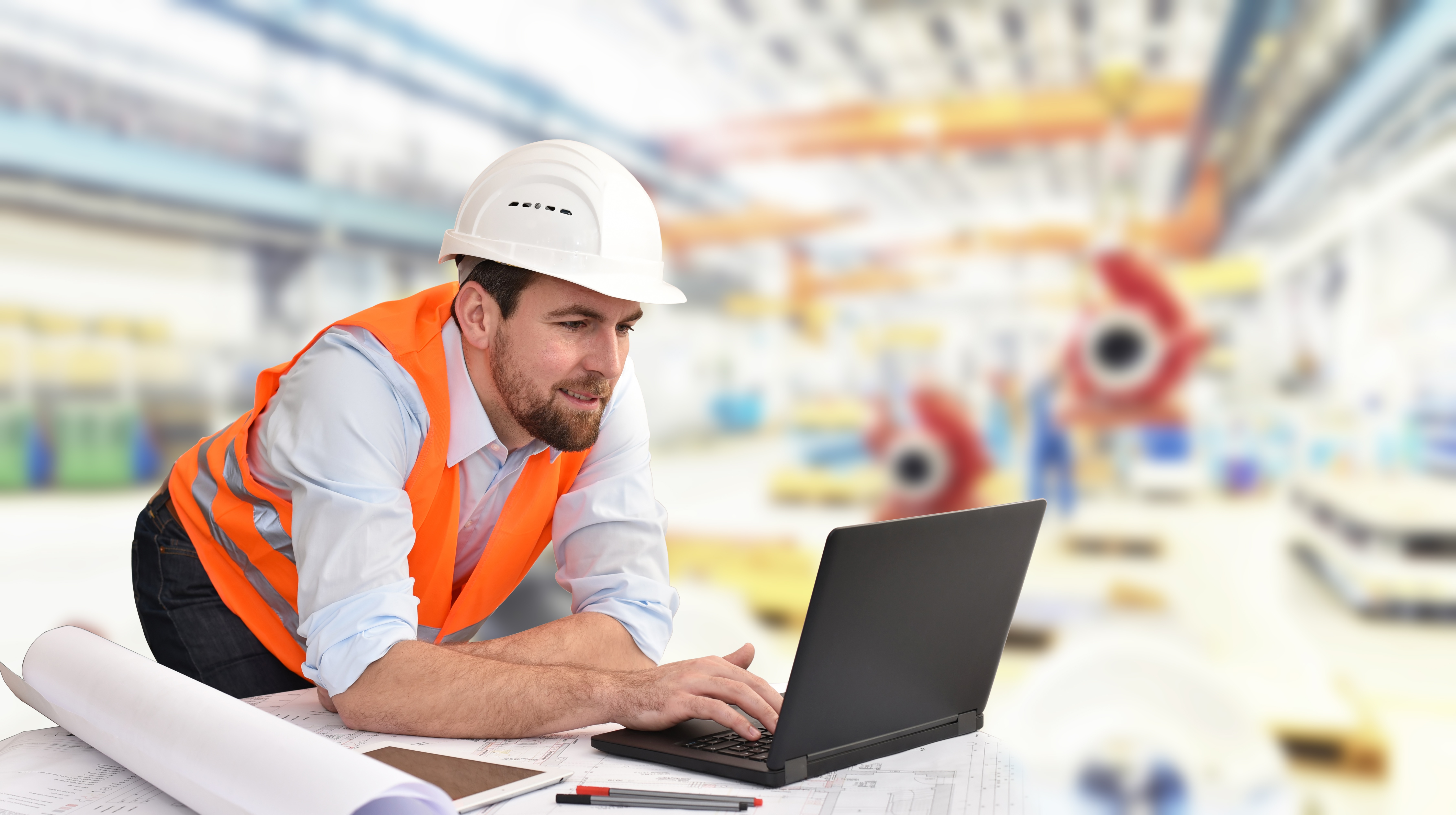 construction worker viewing online training course on laptop