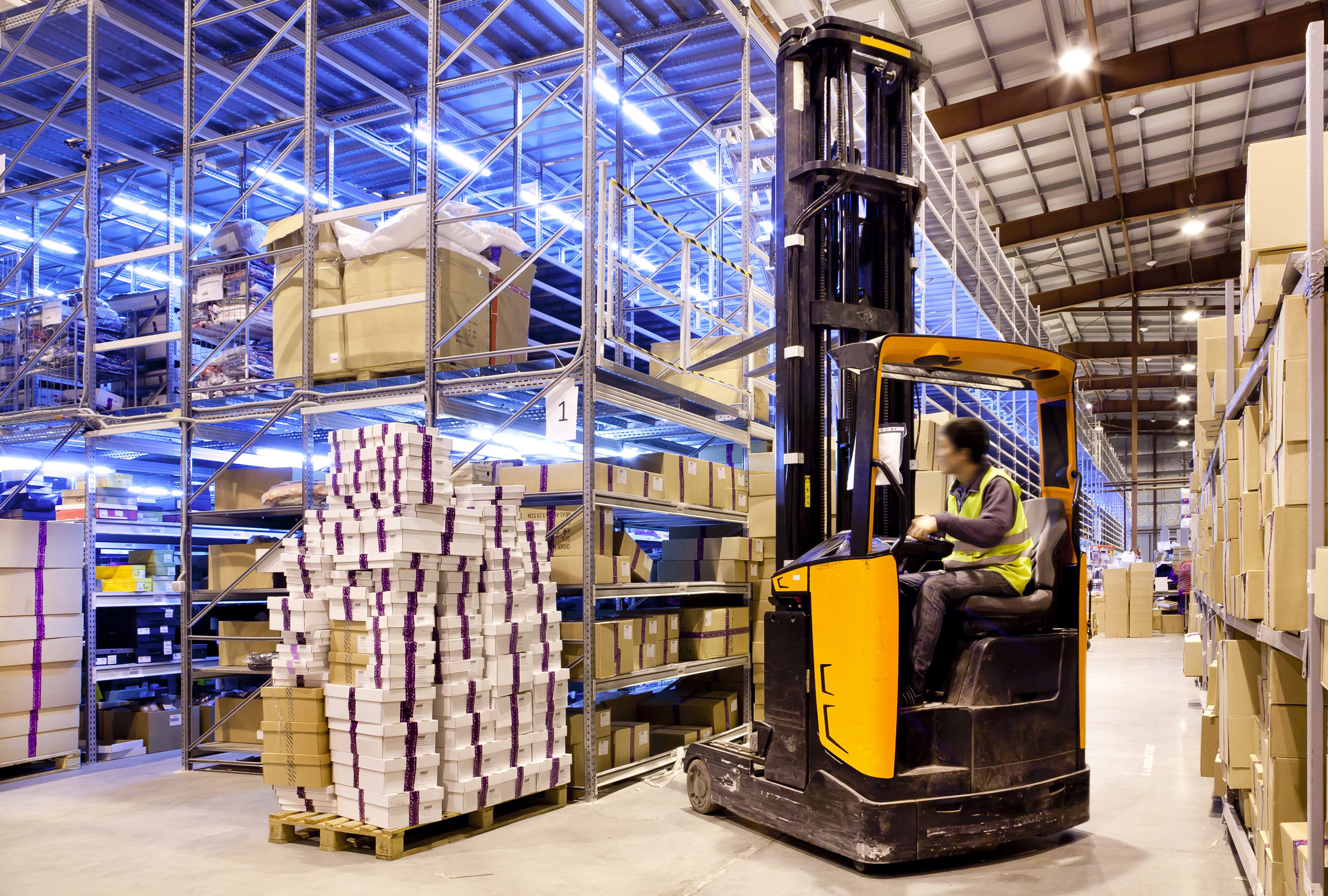 Worker on a forklift in a modern warehouse