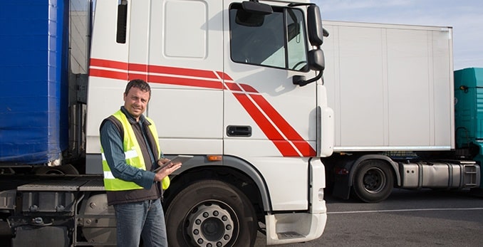 An inspector standing outside of a truck conducting a vehicle-only inspection