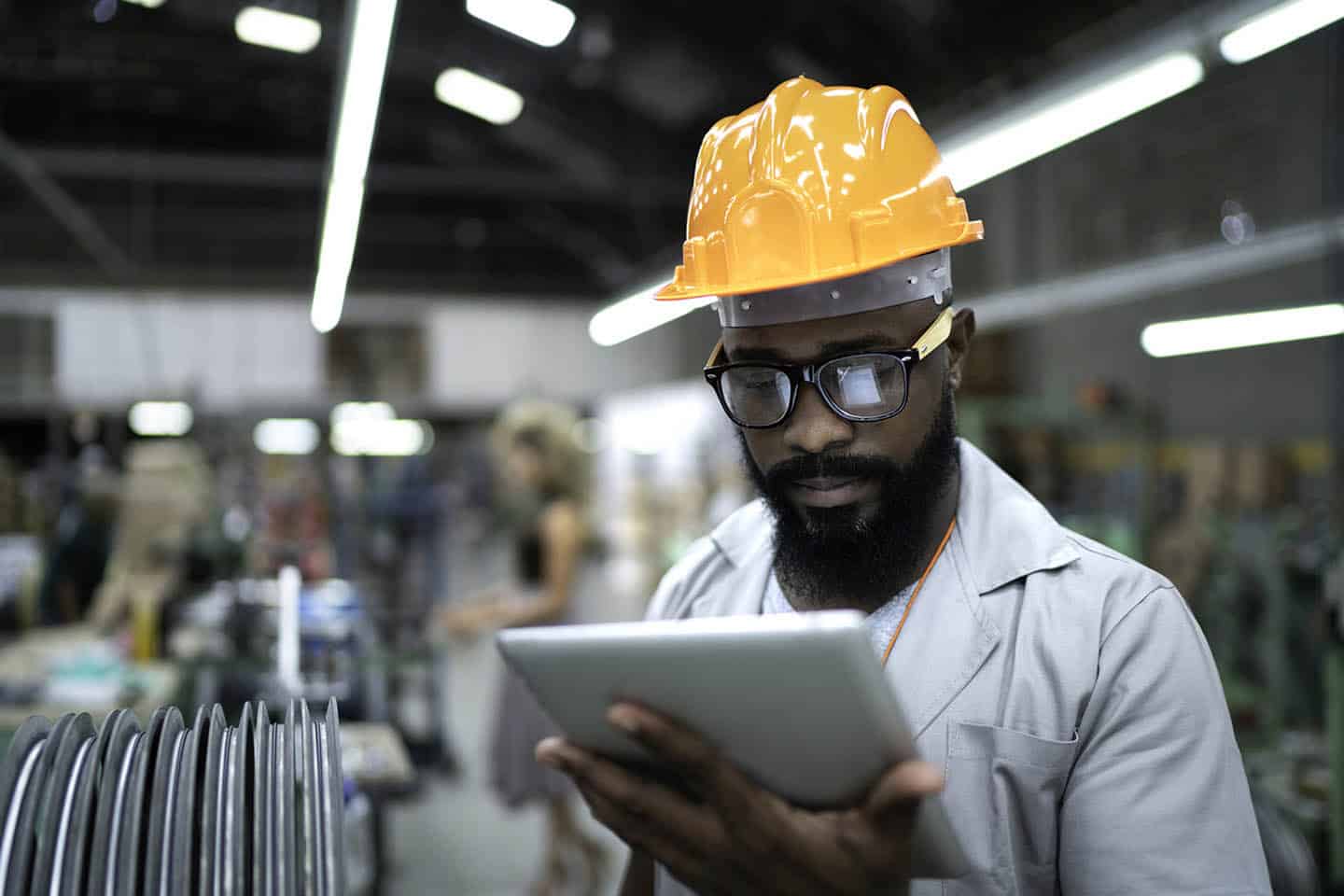Engineer using tablet and working in factory