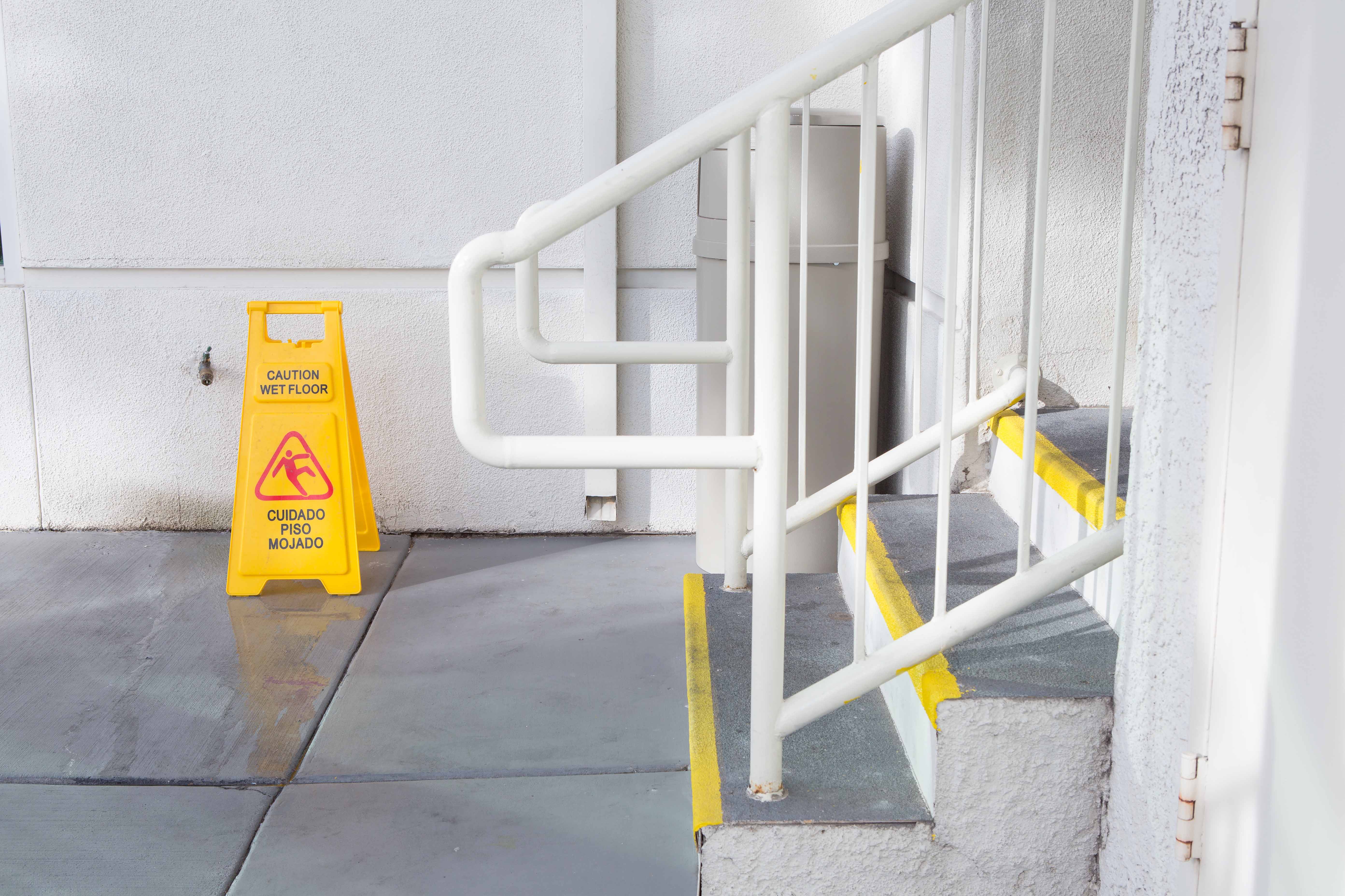 Wet floor sign near stairs