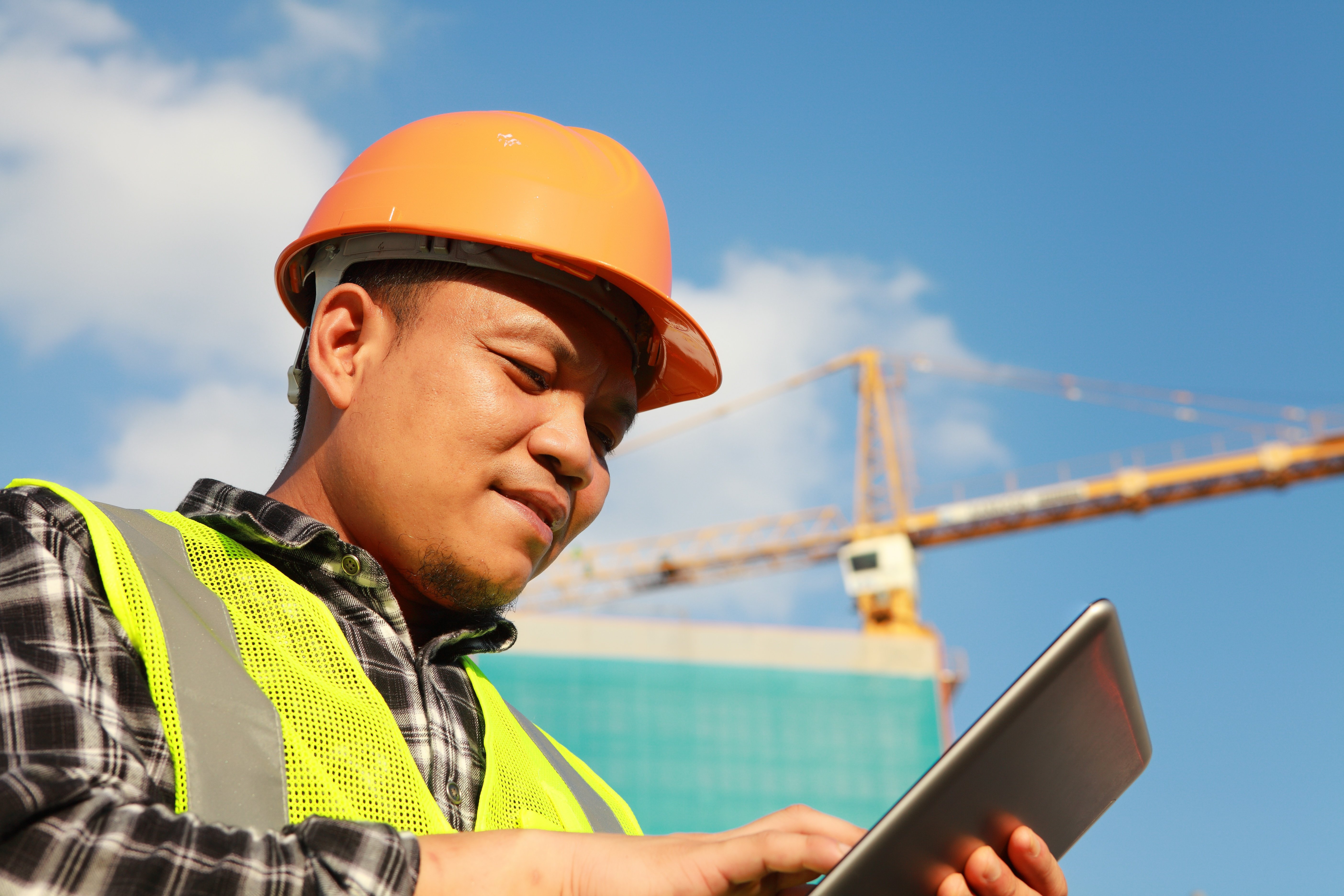 Young safety worker looking at tablet or iPad