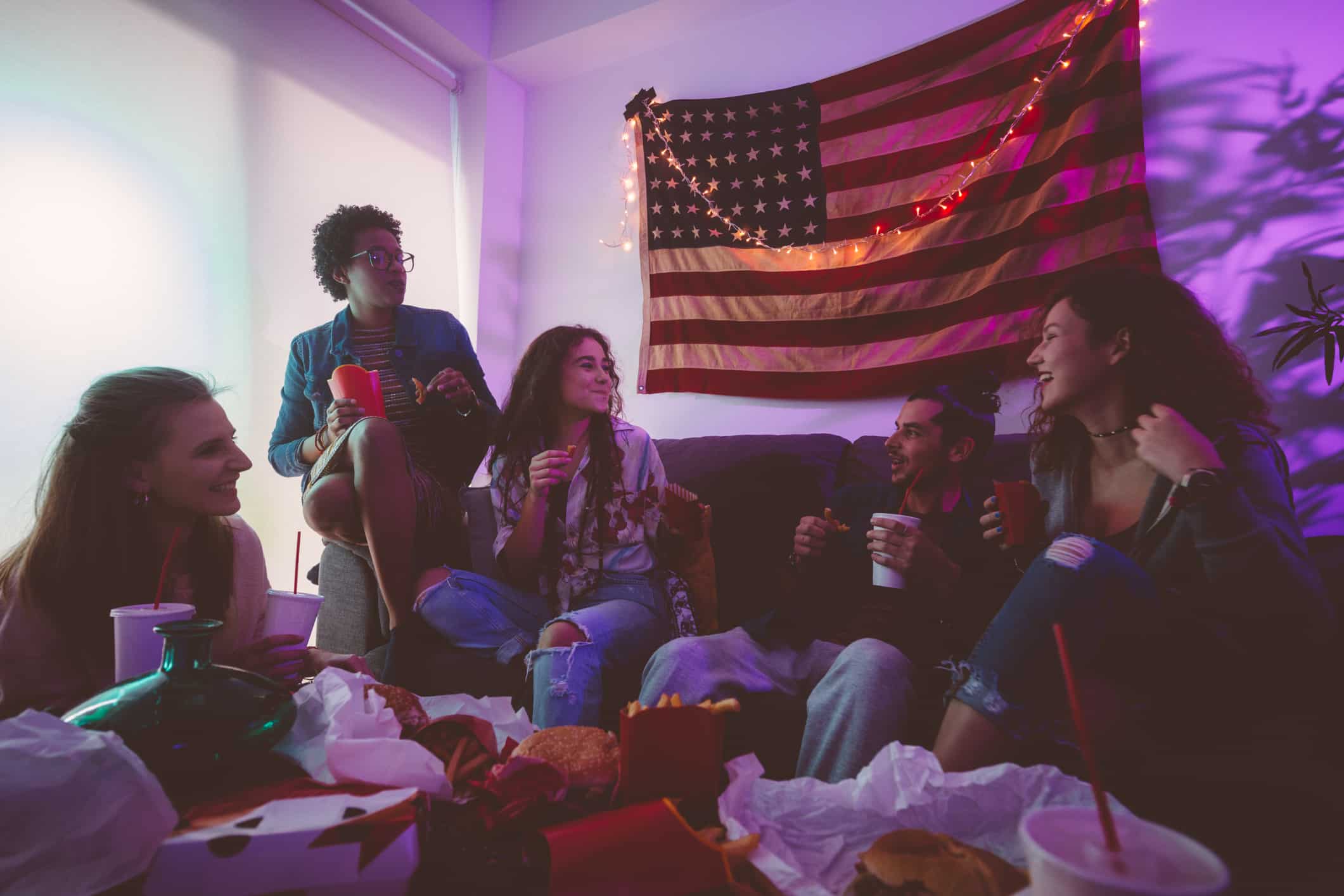 Young Group of Adults Enjoying Takeout on the Couch
