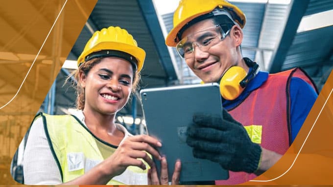 Two employees looking at a tablet