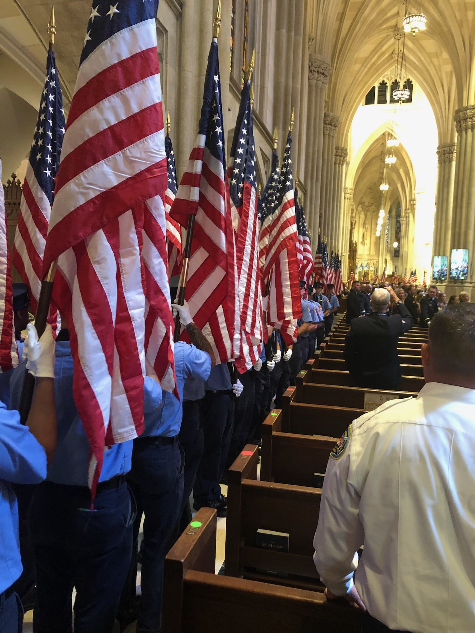 343 FDNY recruits stand with American flags inside St. Patrick’s Cathedral