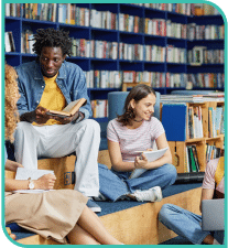 A group of people sitting on a couch in a library
