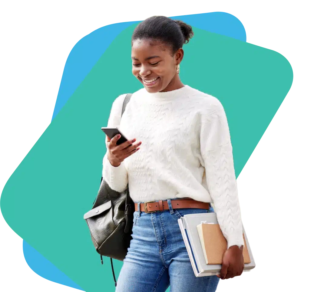 Student holding books in one hand and a phone in another