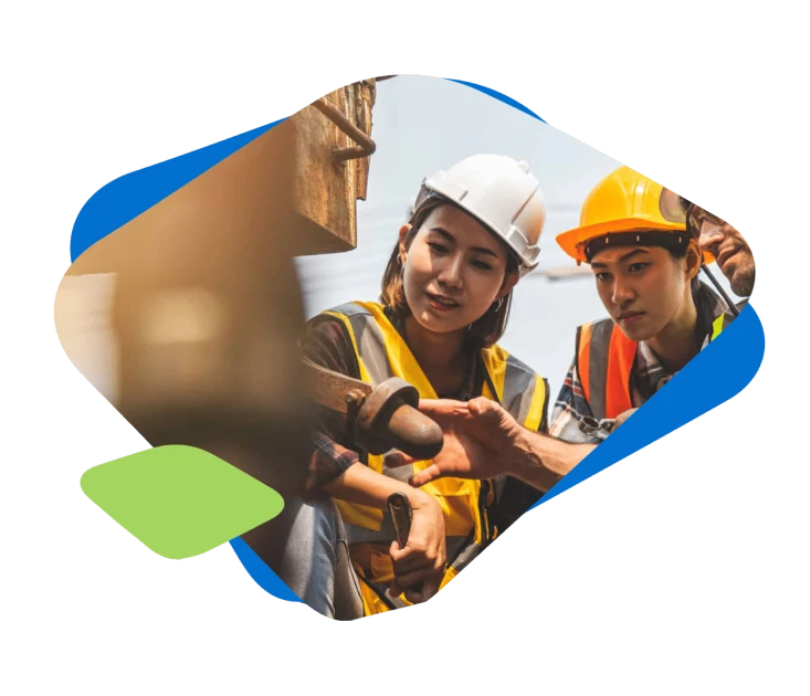 A group of architecture and construction professionals reviews a machine