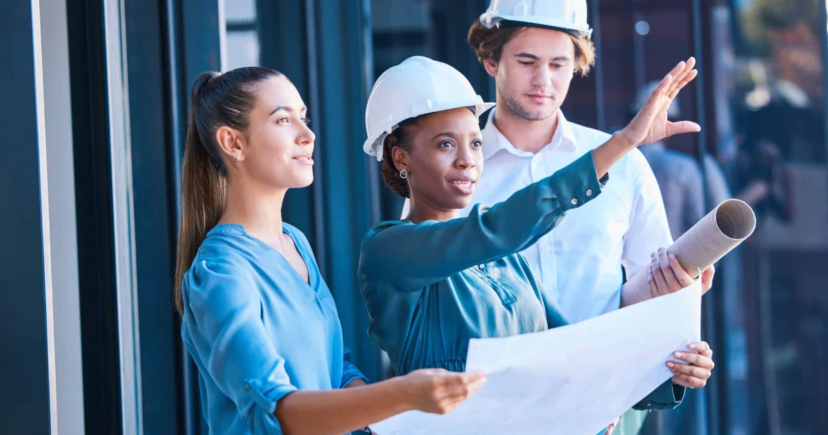 Building construction management team with an architect and engineering blueprint. Teamwork development collaboration of industrial engineer group planning a architecture renovation project.