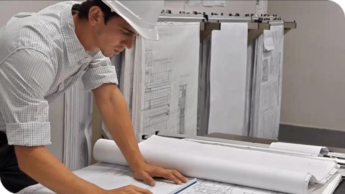 An employee reviewing blueprints