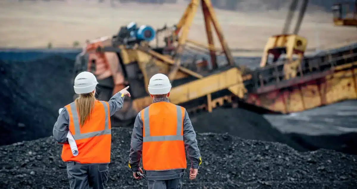 employees at a surface mining site inspecting mining equipment
