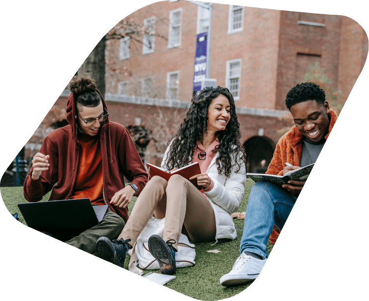 Students sitting on campus lawn