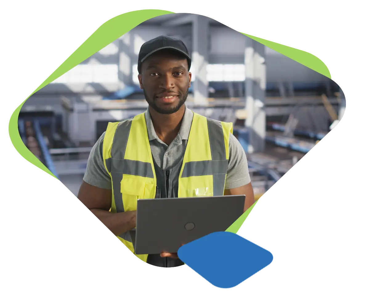 Supply chain worker smiling with laptop