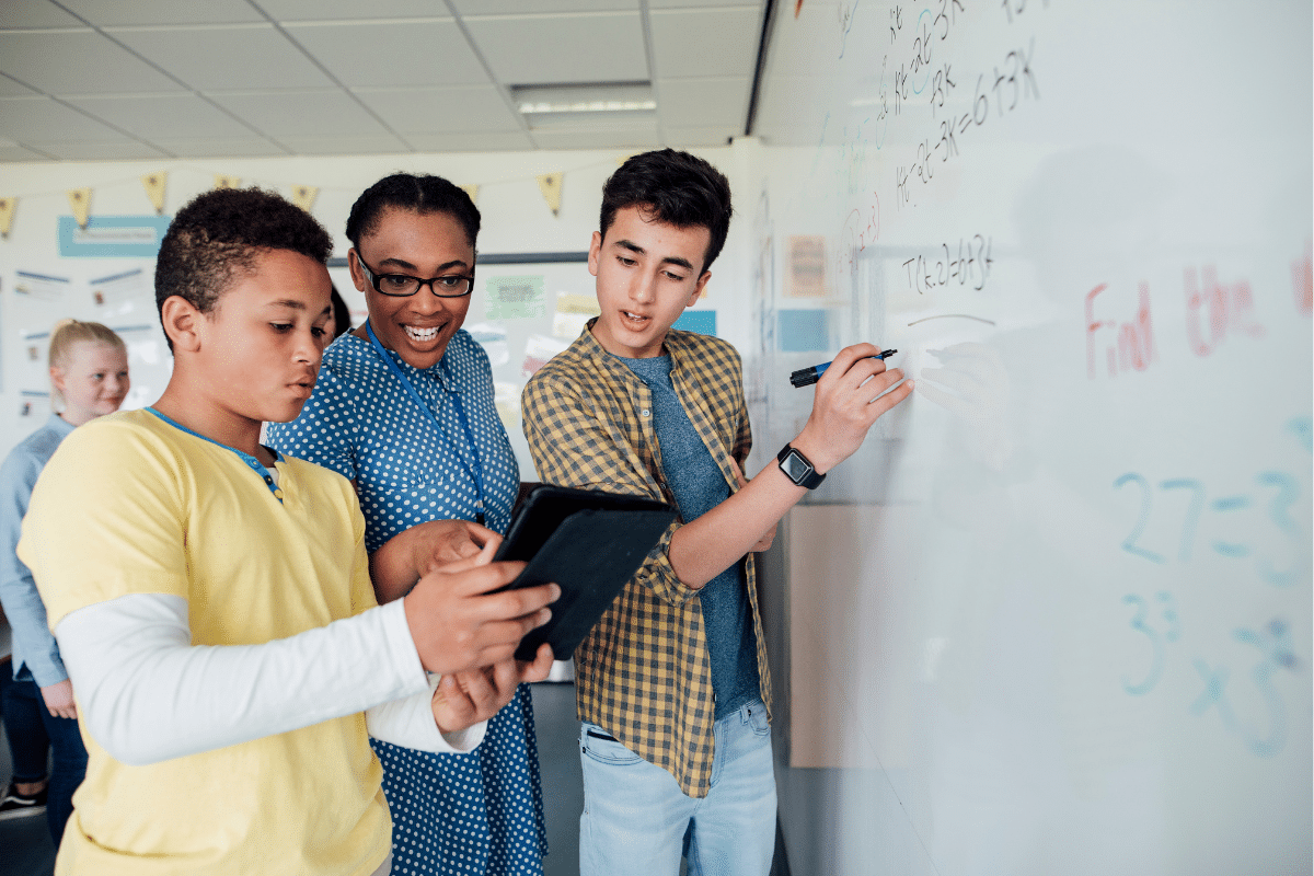 Students writing on whiteboard