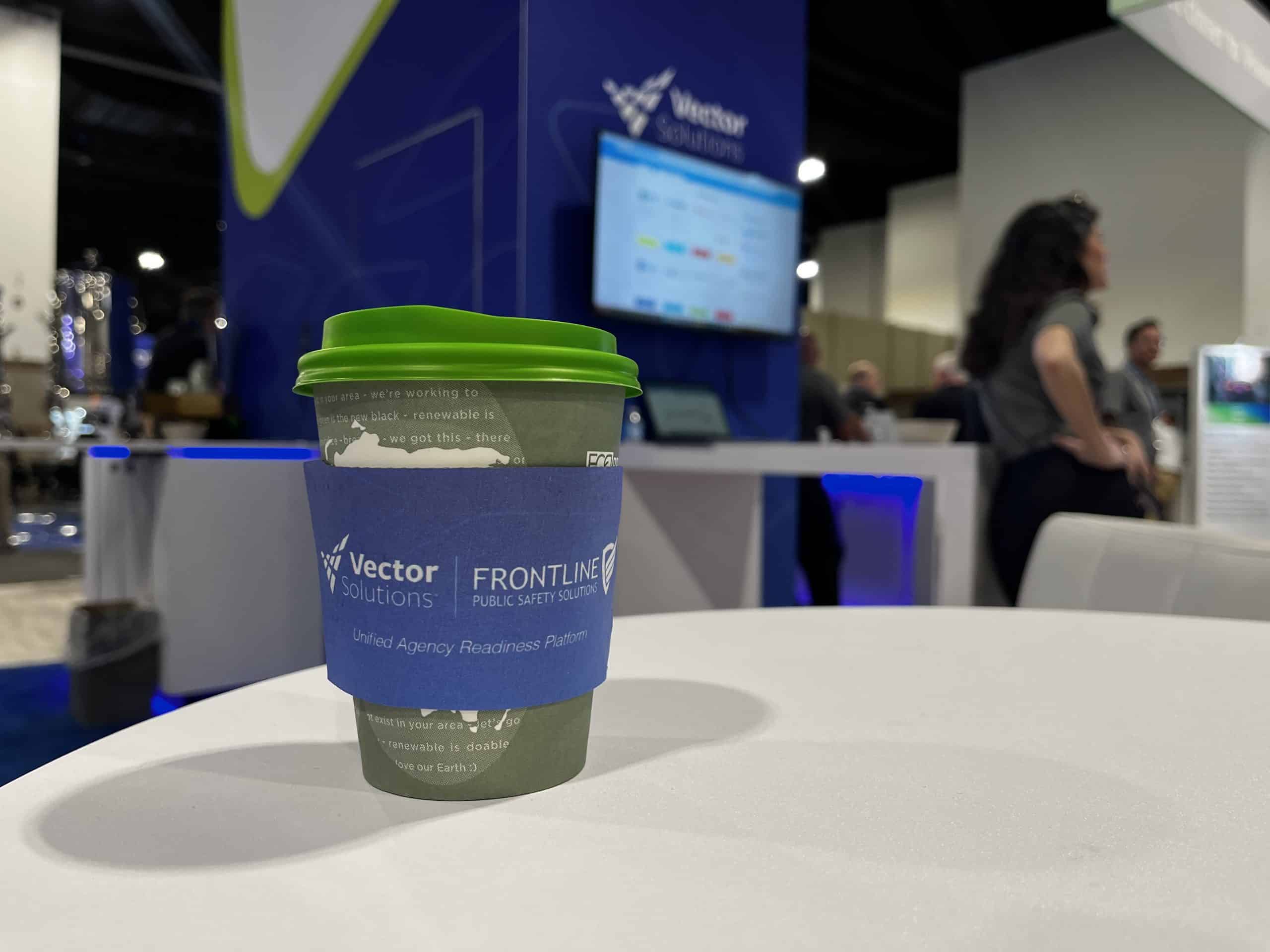 An image of a coffee cup in the Vector Solutions and Frontline booth at IACP 2025. Vector and Frontline have partnered to provide public safety with a comprehensive suite of law enforcement software.