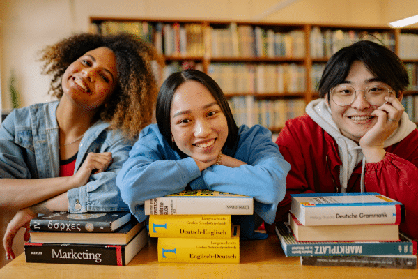 College students smiling in the library