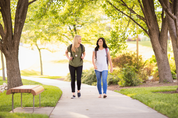 Two college students walking on a college campus