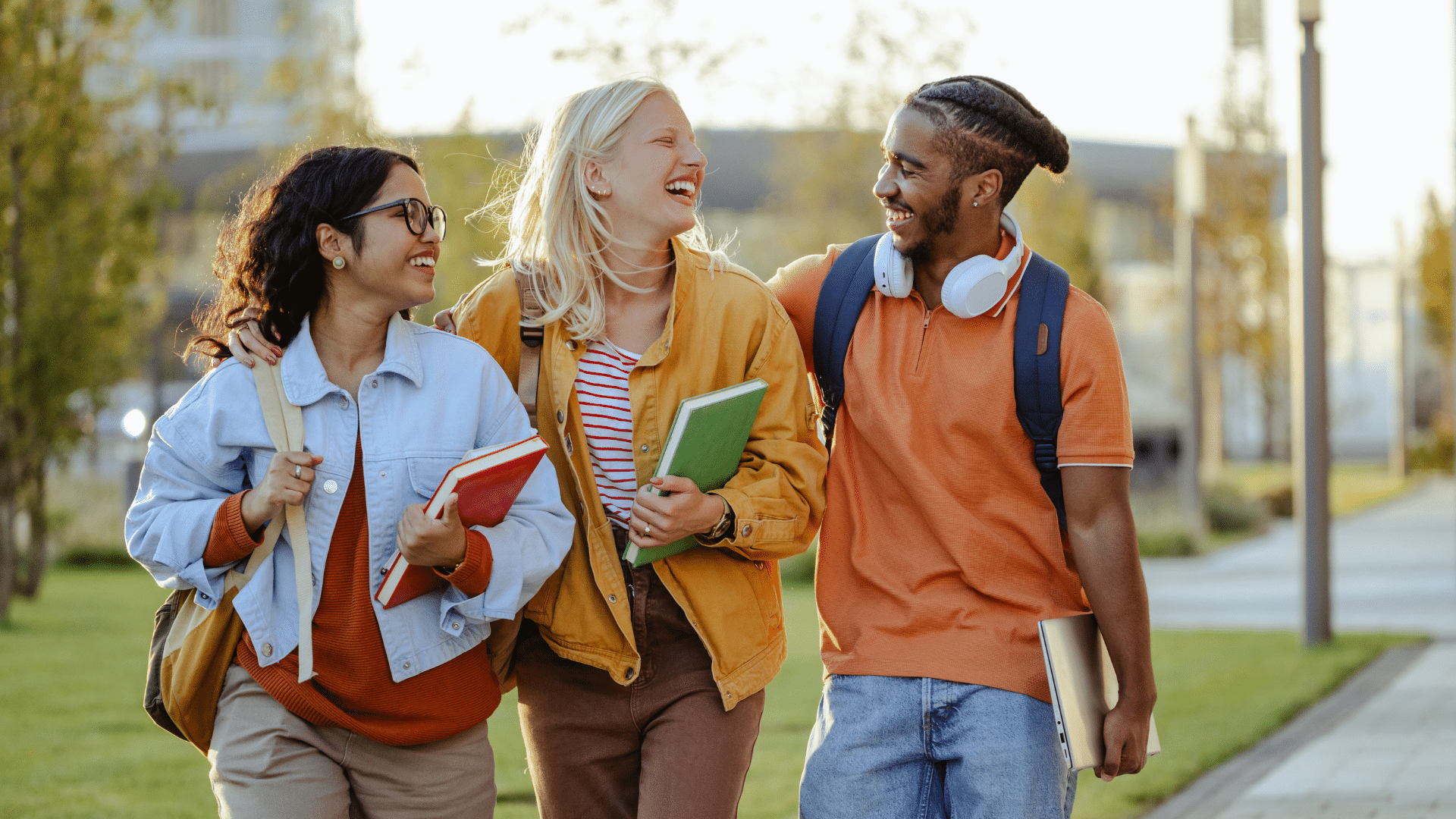 A group of college students smiling and walking together on campus