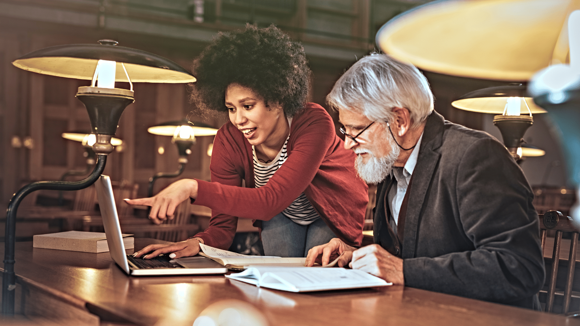 Two college educators reviewing data on a computer.