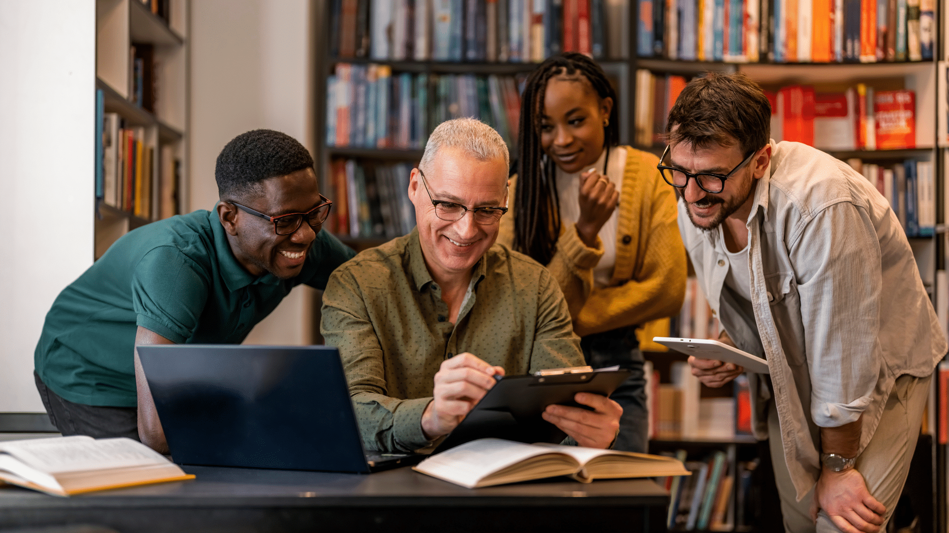 A professor and a group of students reviewing data together.