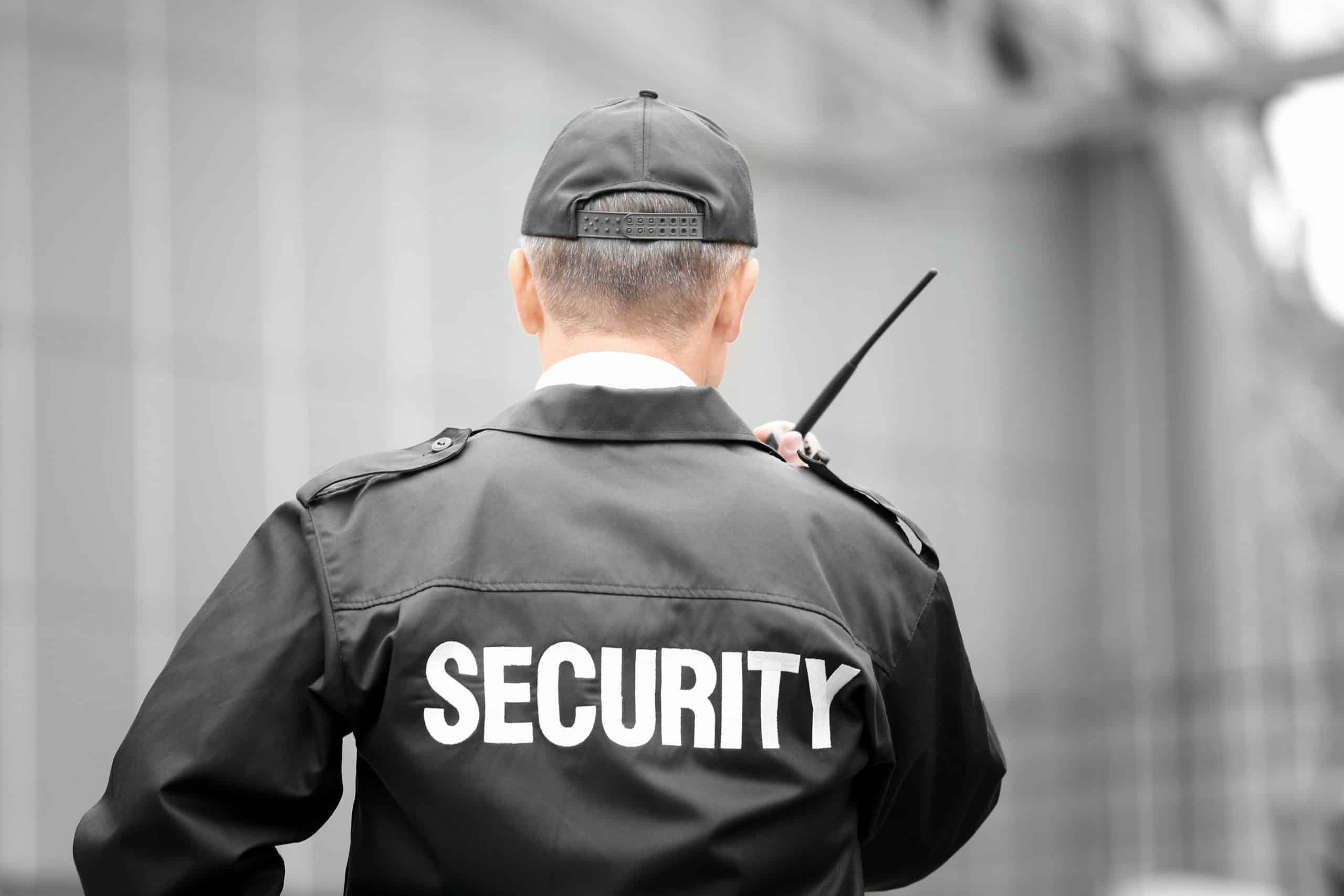 A male security guard using portable radio