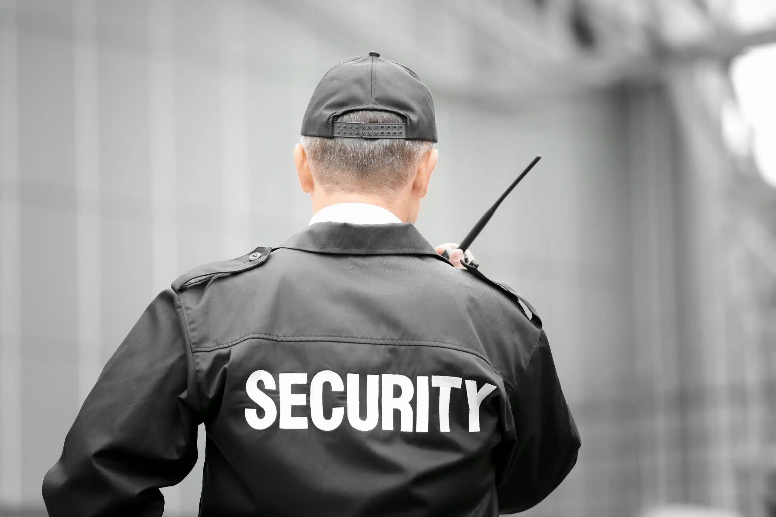 A male security guard using portable radio