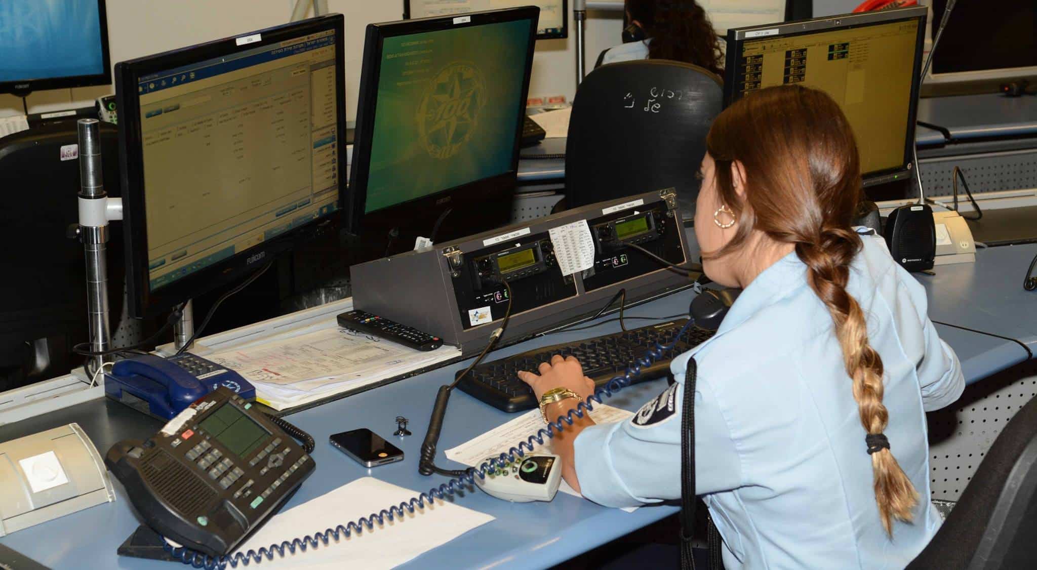 A photo of an emergency telecommunicator supported by vectors policy tracking system for dispatch centers.